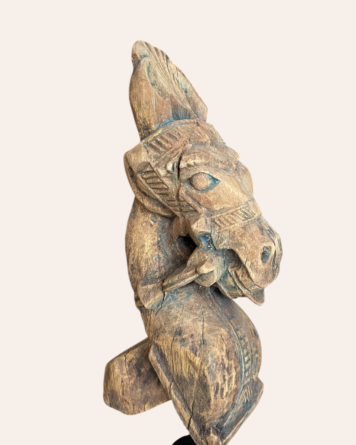 vintage distressed hand-carved wooden horse bracket on iron stand